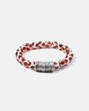 Beaded bracelet with red and white pattern on a white background
