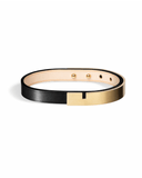 Black leather bracelet with matte gold clasp on a white background