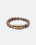 Bracelet with beads and a gold accent on a white background
