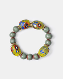 Bracelet with green beads and colorful patterned beads on a white background