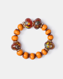Bracelet with orange and brown beads on a white background