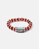 Bracelet with red and white beads and a silver clasp on a white background