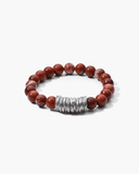 Bracelet with red beads and a silver clasp on a white background