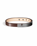 Brown leather bracelet with matte charcoal clasp on a white background