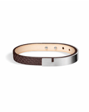 Brown python leather bracelet with matte silver clasp on a white background