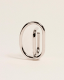 Silver ear-cuff on a beige background