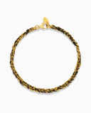 Gold and black silk braided bracelet on a white background