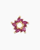 Gold and pink flower-shaped charm spacer on a white background