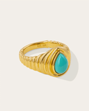 Gold ring with a turquoise stone on a white background