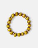 Green beaded bracelet with gold accents on a white background