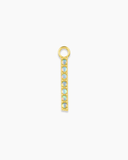 Long gold charm with blue stones on a white background