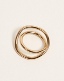 Gold ring with a textured surface on a light beige background