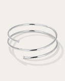 Mini silver bangle bracelet on a light gray background