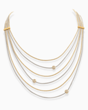Multi-layered necklace with gold and silver chains on a white background