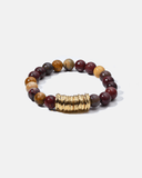 Multicolored beaded bracelet with a gold accent on a white background