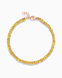 Neon yellow and rose gold silk braided bracelet on a white background