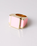 Gold ring with pink square stone on a light gray background