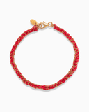 Red and gold silk braided bracelet on a white background