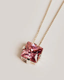 Pink gemstone necklace on a light background