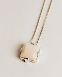 Necklace with a small, rectangular pendant on a light background