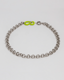 Silver chain necklace with a green clasp on a white background