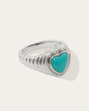 Silver ring with a turquoise heart-shaped stone on a white background