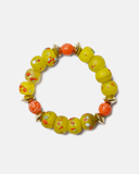 Beaded bracelet with yellow and orange beads on a white background