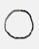 Beaded necklace with black and white beads on a white background