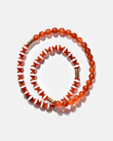 Beaded necklace with orange, white, and gold beads on a light gray background