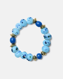 Blue beaded bracelet with gold accents on a white background