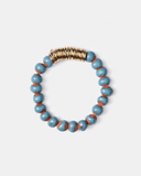 Bracelet with blue and brown terracotta beads with gold spacers on a white background
