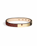Burgundy python leather bracelet with glossy gold clasp on a white background