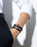 Close-up of a black leather wrap bracelet on a wrist