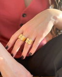Close-up of a hand wearing two gold rings 