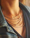 Close-up of a layered gold chain necklace