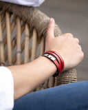 Close-up of a red leather wrap bracelet on a wrist