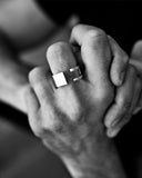 Close-up of a silver ring with a unique design on a white background