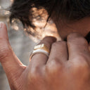 Close-up of a two-toned ring with gold and silver design on a white background
