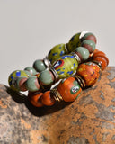Colorful artisan beaded bracelets on a textured surface
