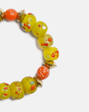 Colorful beaded bracelet with yellow and orange beads on a white background