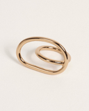 Gold ring with a modern design on a light beige background