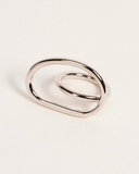 Silver ring with a modern design on a light beige background