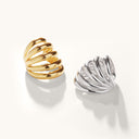 Gold and silver ear-cuffs on a white background