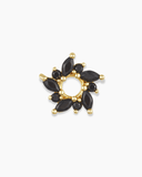 Gold and black flower-shaped charm spacer on a white background