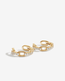Gold chain-style ear cuffs with clear stones on a white background