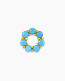 Gold charm spacer with turquoise blue stones on a white background