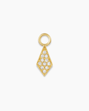 Gold charm with embedded stones on a white background