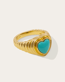 Gold ring with a turquoise heart-shaped stone on a white background