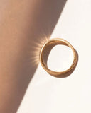 Gold ring on a light background