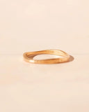 Gold ring on a beige background